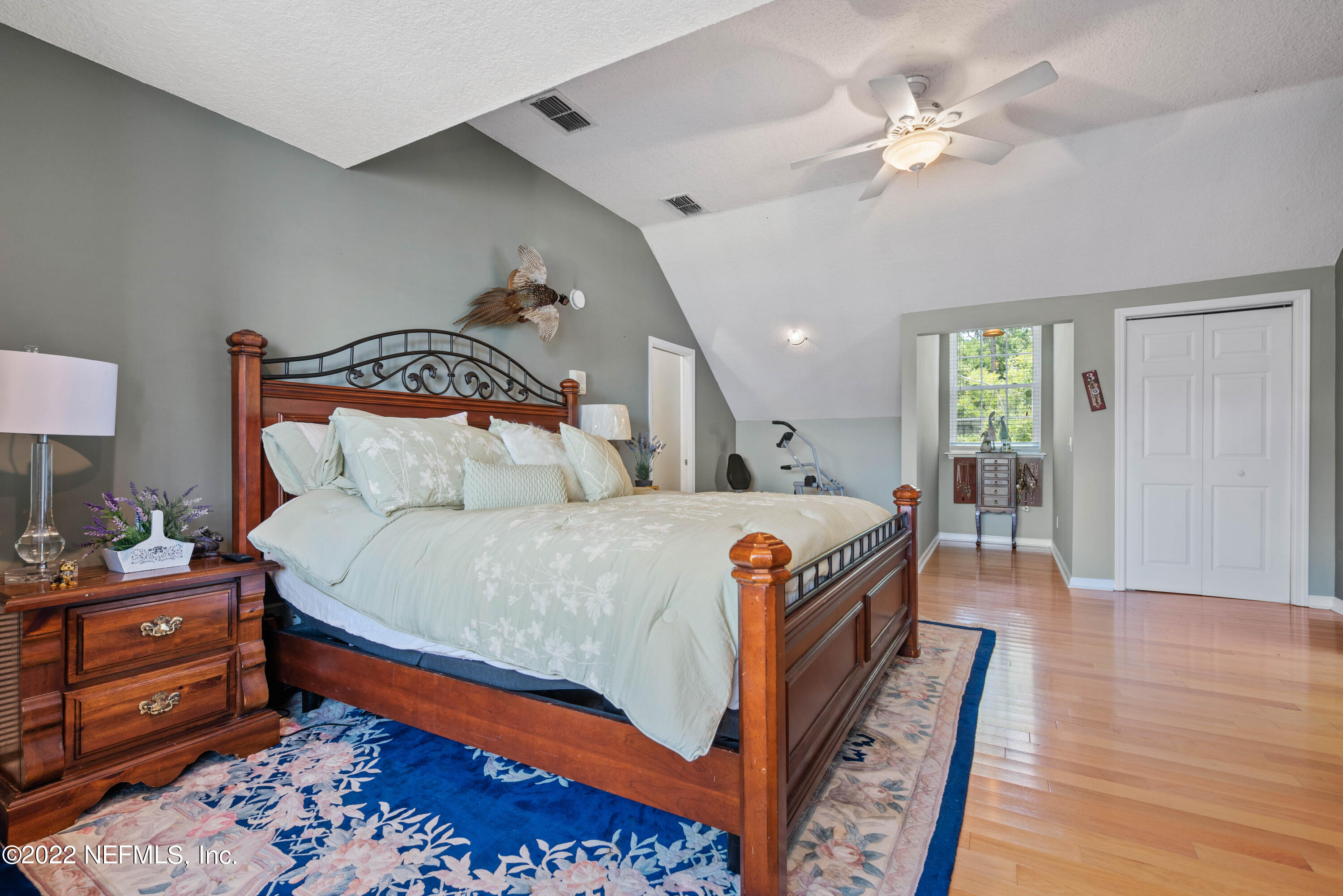 5345 Pine Avenue Fleming Island, FL 32003 - Photo 23 of 39 a bedroom with bed and wooden floor