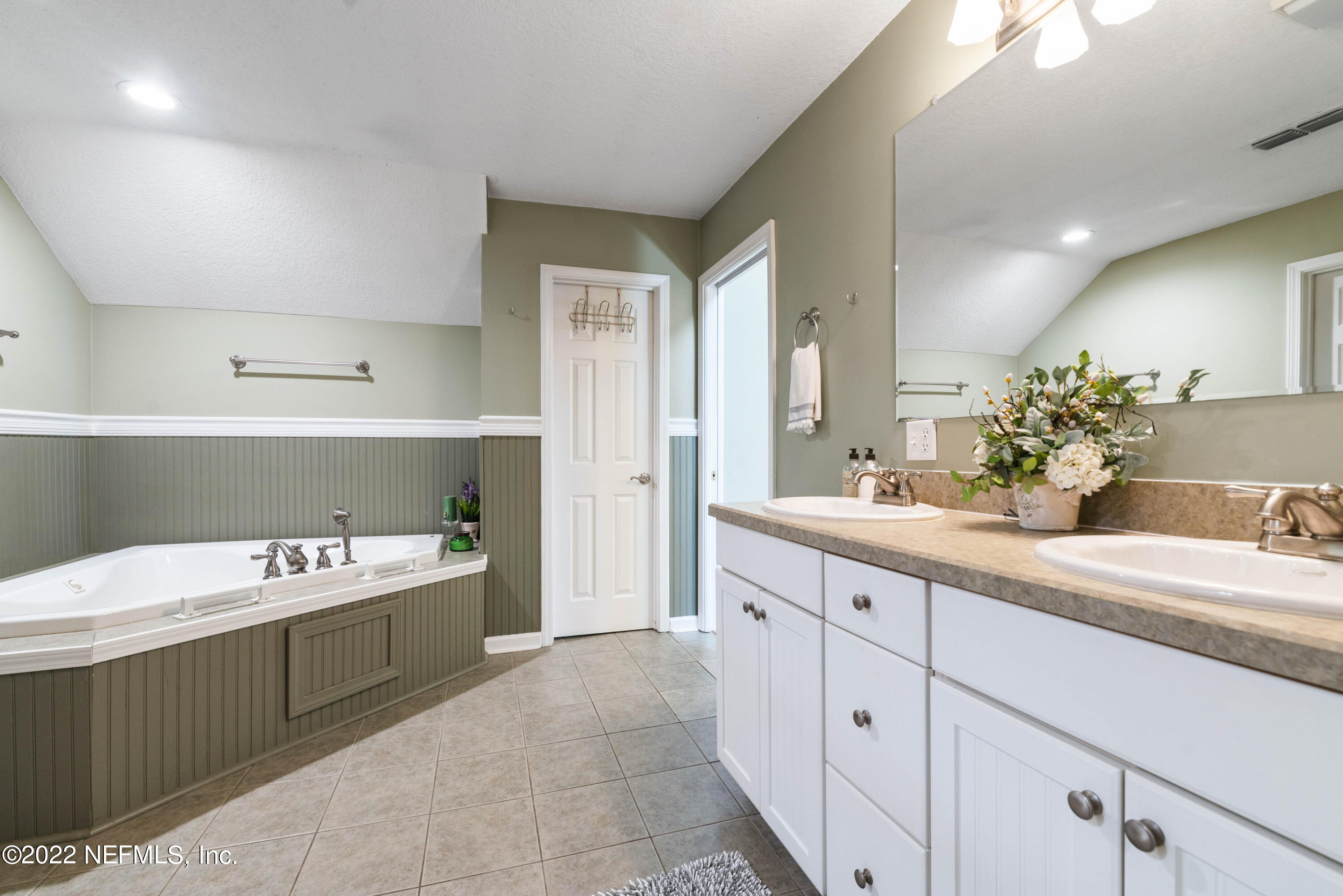 5345 Pine Avenue Fleming Island, FL 32003 - Photo 26 of 39 a spacious bathroom with a sink a mirror and a bathtub