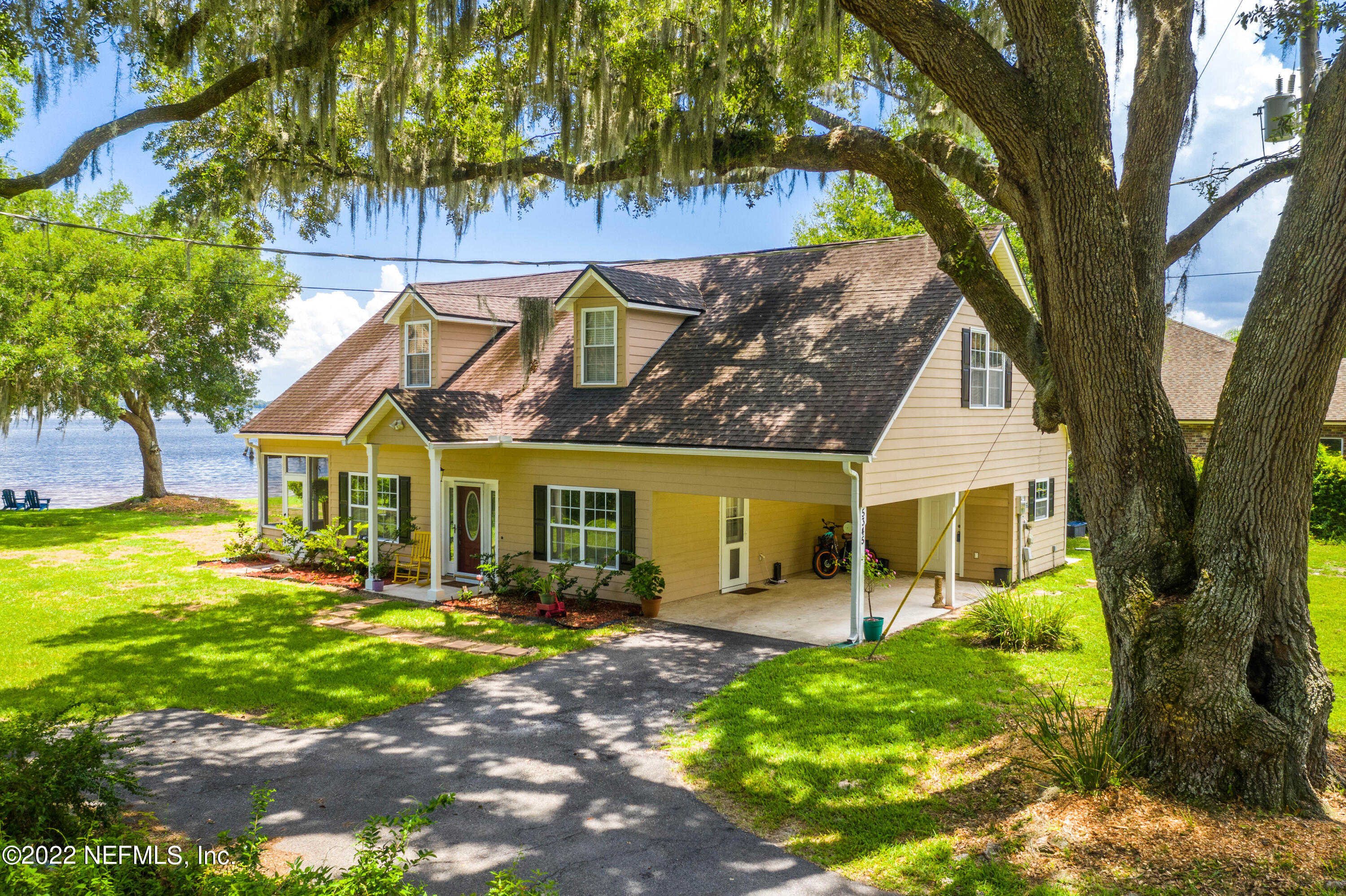 5345 Pine Avenue Fleming Island, FL 32003 - Photo 3 of 39 a front view of a house with garden