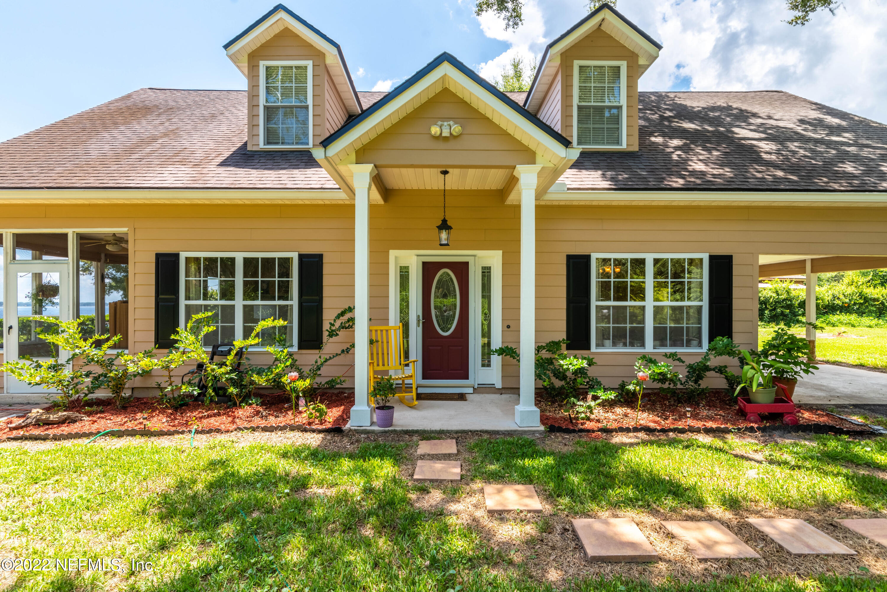 5345 Pine Avenue Fleming Island, FL 32003 - Photo 4 of 39 a front view of a house with garden