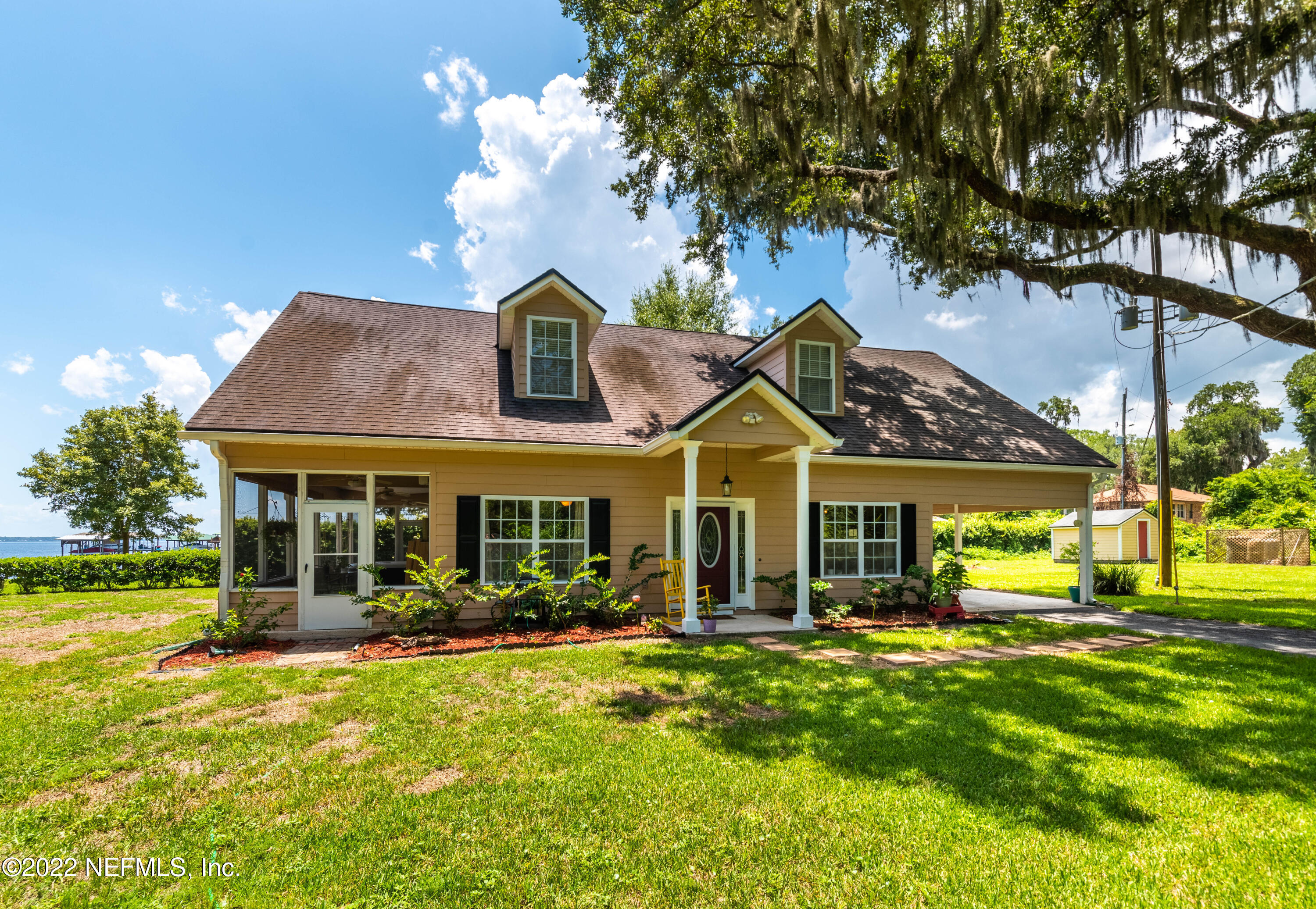 5345 Pine Avenue Fleming Island, FL 32003 - Photo 5 of 39 a view of a house with a big yard and large trees
