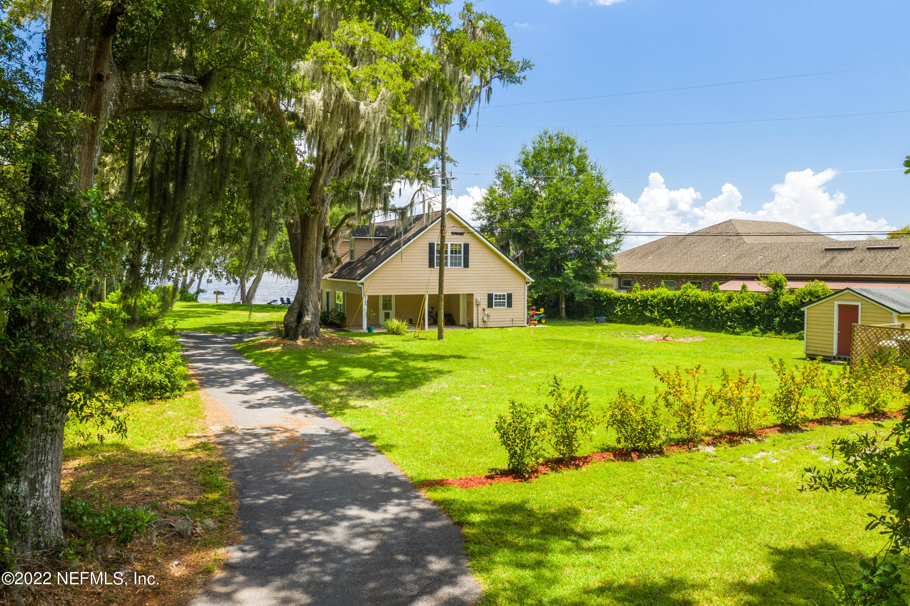 5345 Pine Avenue Fleming Island, FL 32003 - Photo 6 of 39 a house view with a garden space