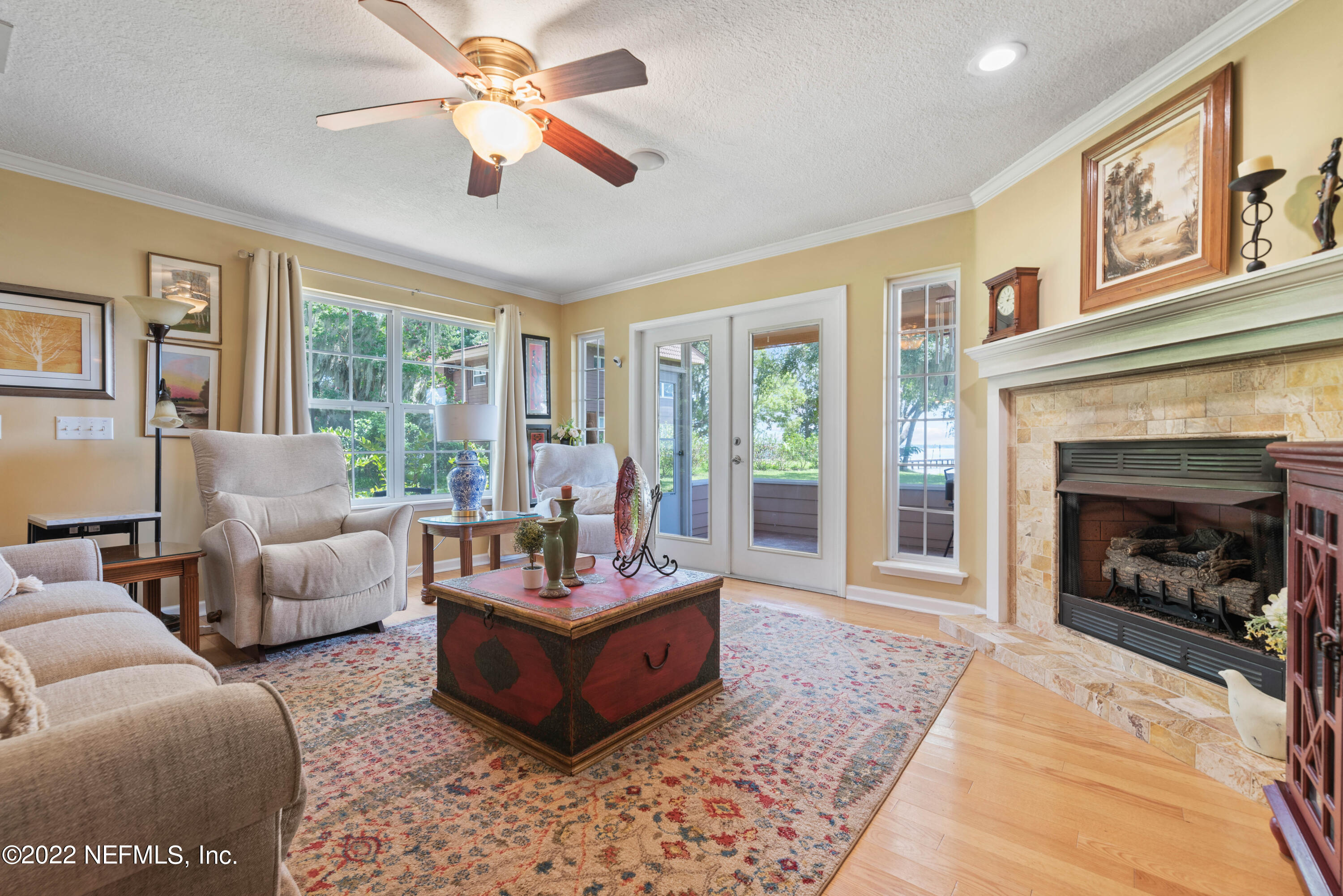 5345 Pine Avenue Fleming Island, FL 32003 - Photo 9 of 39 a living room with furniture and a fireplace