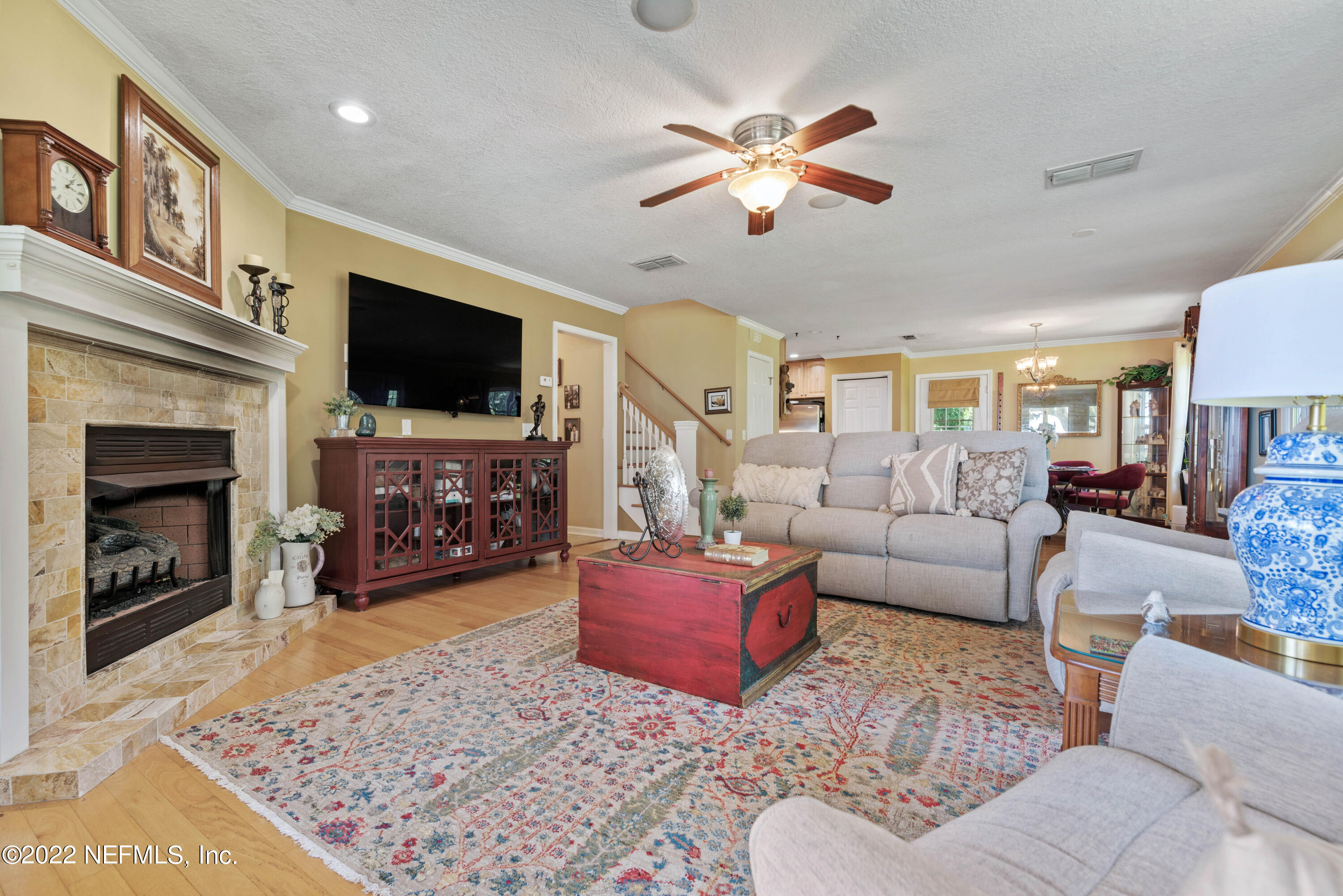 5345 Pine Avenue Fleming Island, FL 32003 - Photo 10 of 39 a living room with furniture a flat screen tv and a fireplace