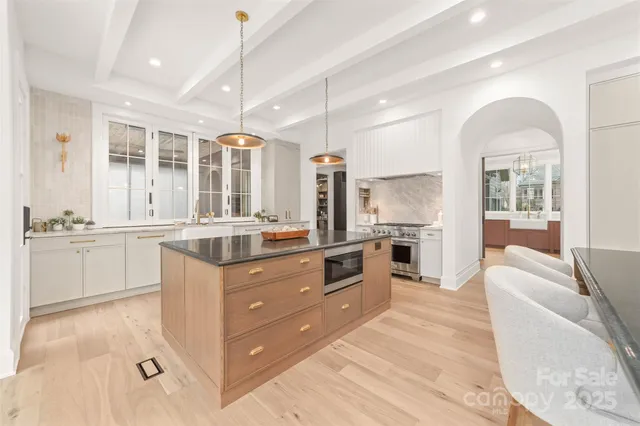 a kitchen with a sink cabinets and wooden floor
