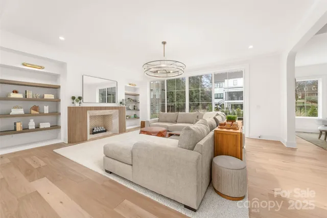 a living room with furniture and a chandelier