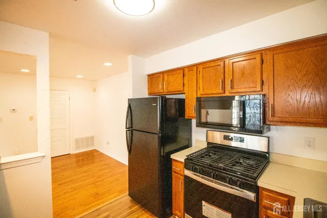 a kitchen with a refrigerator stove and microwave