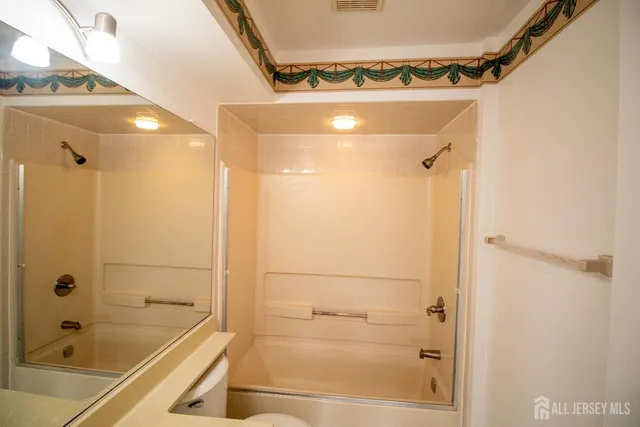 a bathroom with a tub and shower