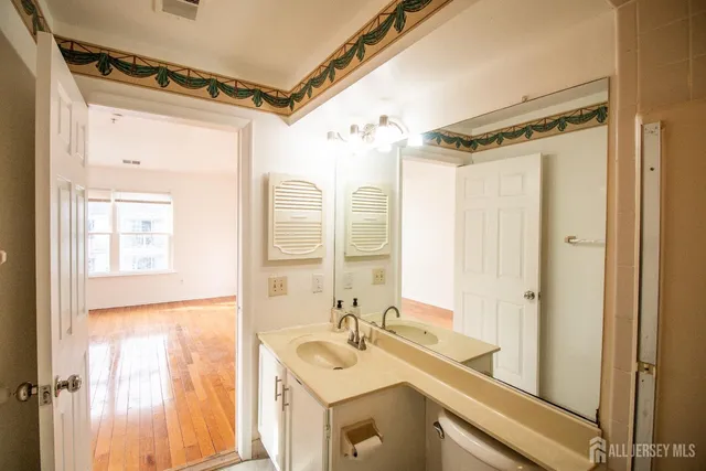 a bathroom with a sink mirror and a shower