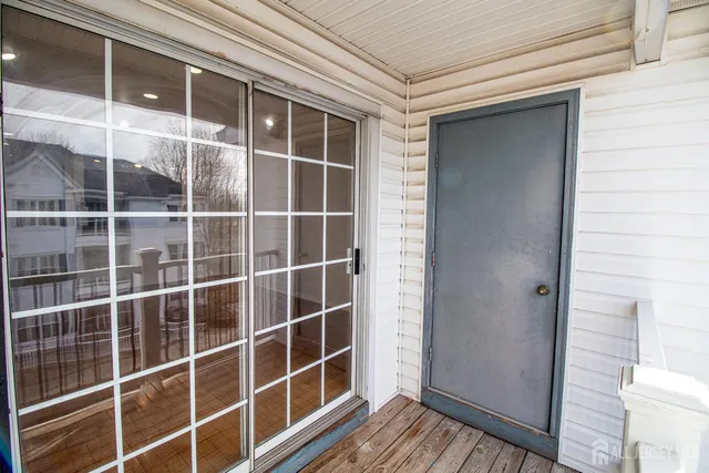 a view of a walk in closet and wooden floor
