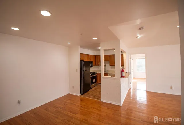 a view of a living room a refrigerator and a stove