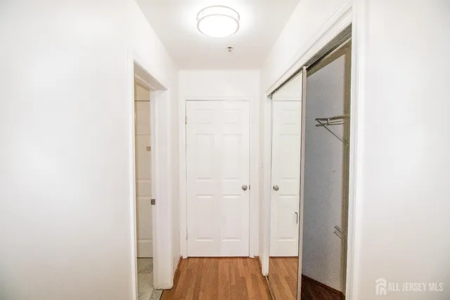 a view of a hallway with wooden floor