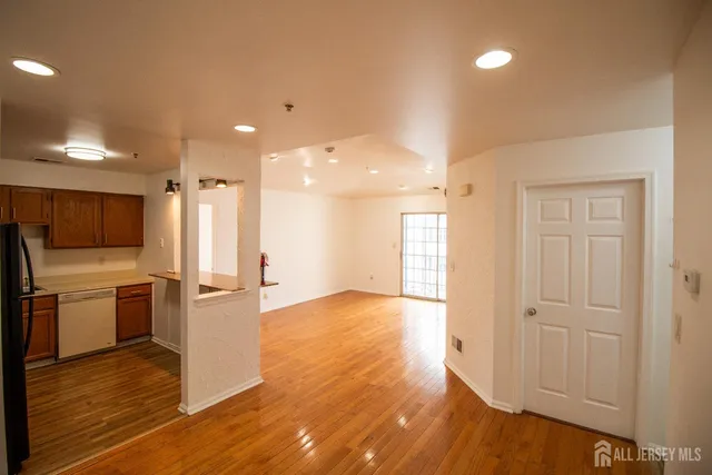 a view of a kitchen with a sink and a refrigerator