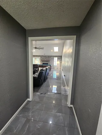 a hallway with a view of living room