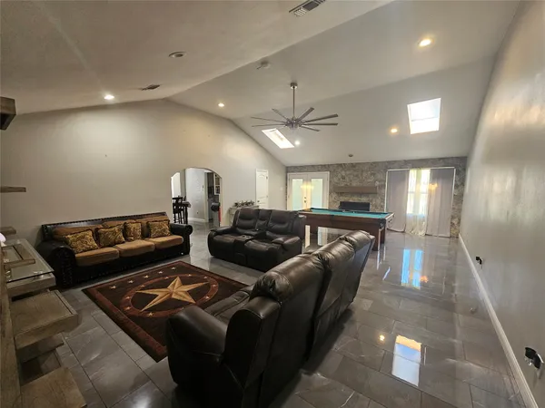 a living room with furniture and a chandelier