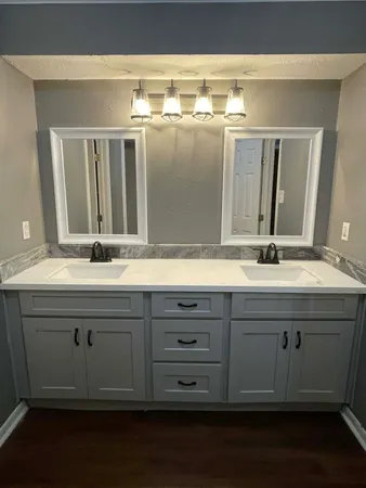 a bathroom with a double vanity sink and mirror