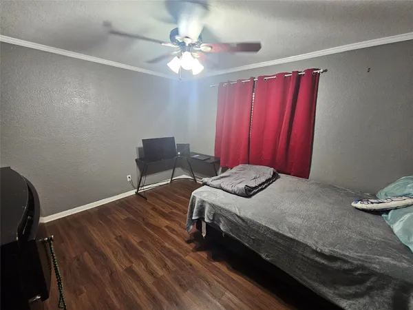 a bedroom with a bed and a mirror