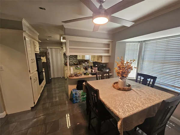 a view of a dining room with furniture and window
