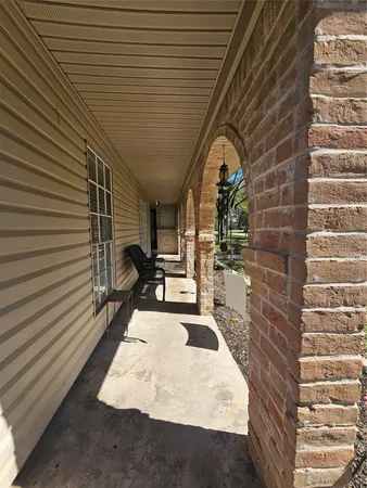a view of a patio with a table and chairs
