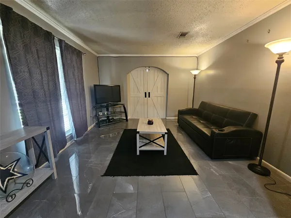 a living room with furniture and a mirror