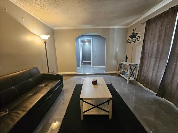 a living room with furniture fireplace and wooden floor