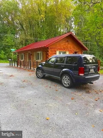 a blue car parked in front of a house
