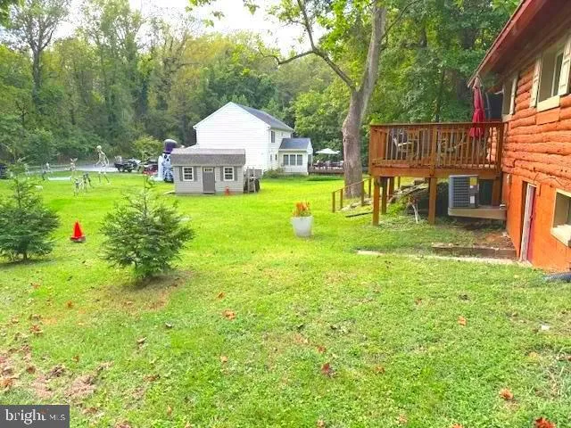 a view of a house with pool and chairs