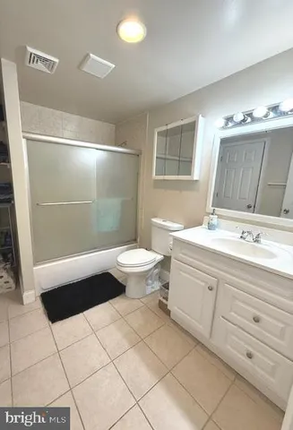 a bathroom with a sink a toilet and a shower