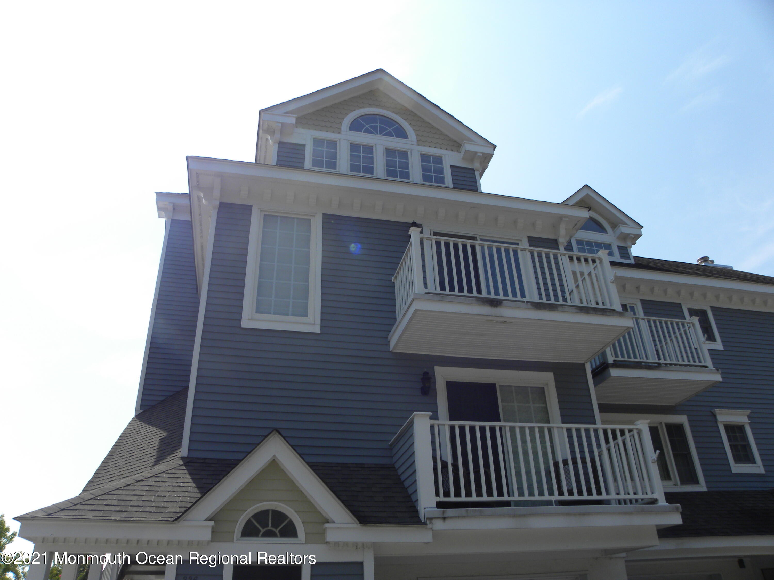a front view of a house with iron fence
