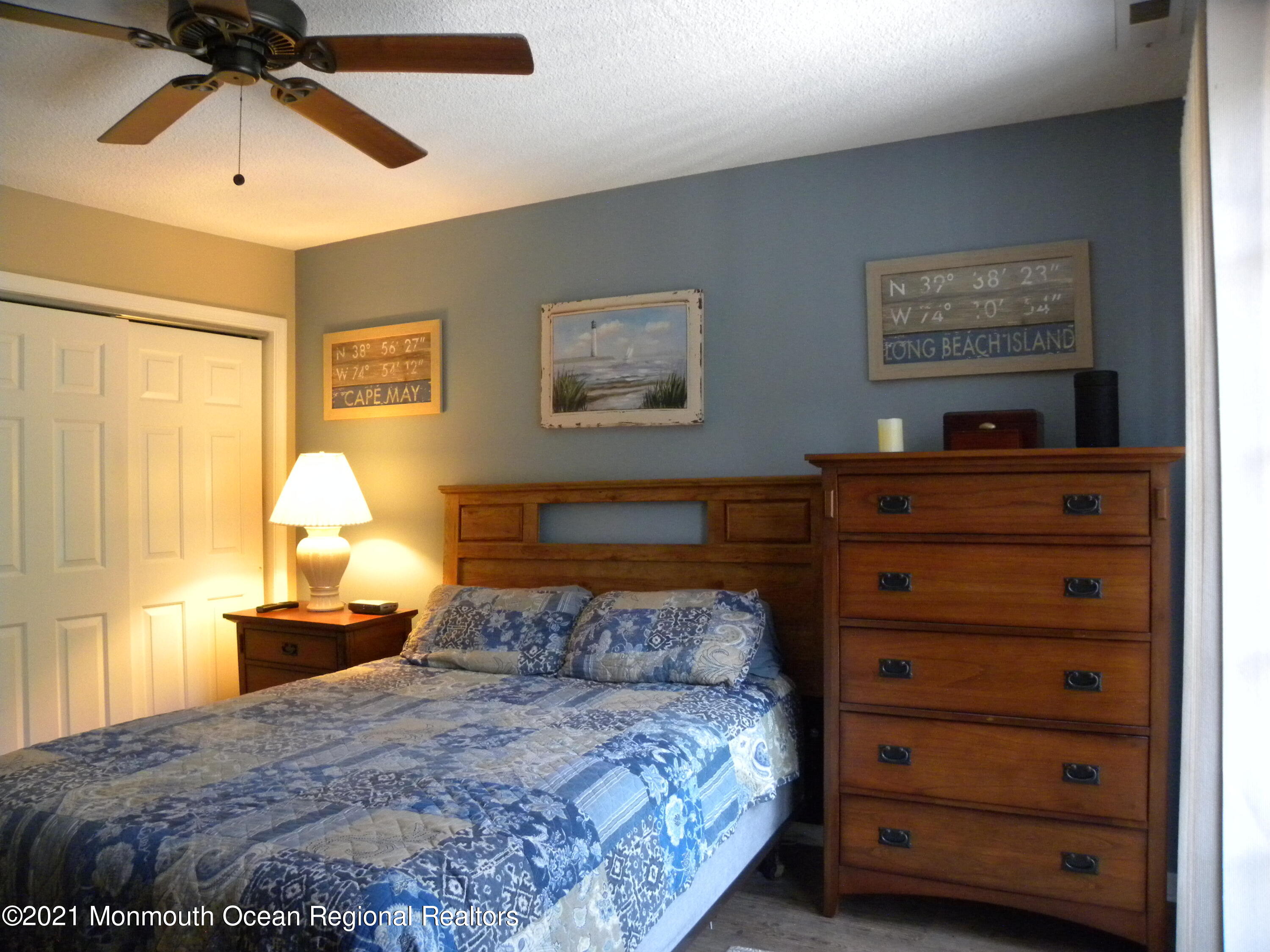 337 Lacey Road, Unit 37 Forked River, NJ 08731 - Photo 13 of 34 a bedroom with a bed and a chandelier