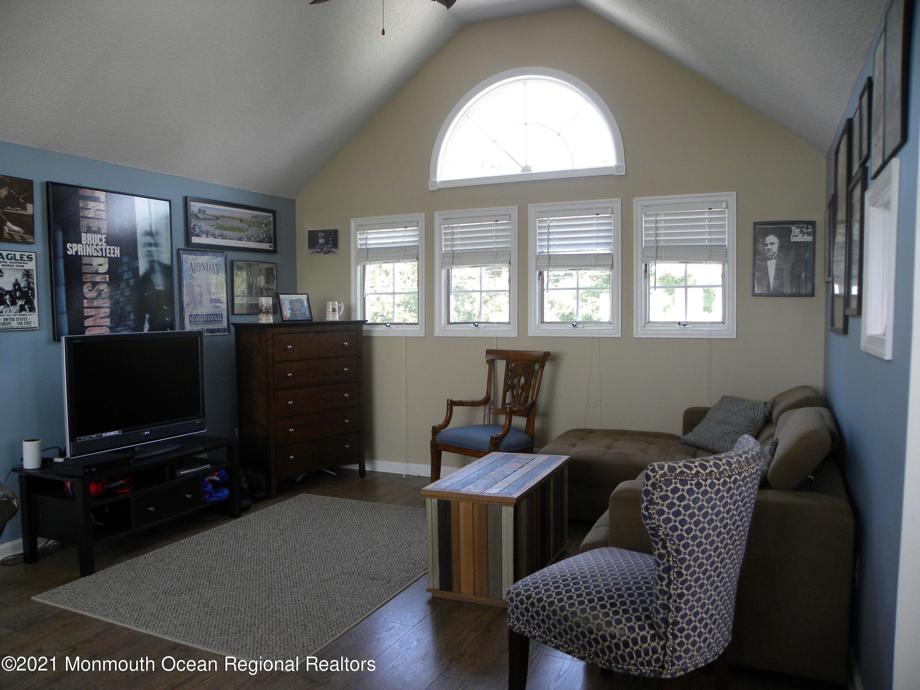337 Lacey Road, Unit 37 Forked River, NJ 08731 - Photo 18 of 34 a living room with furniture a flat screen tv and a window