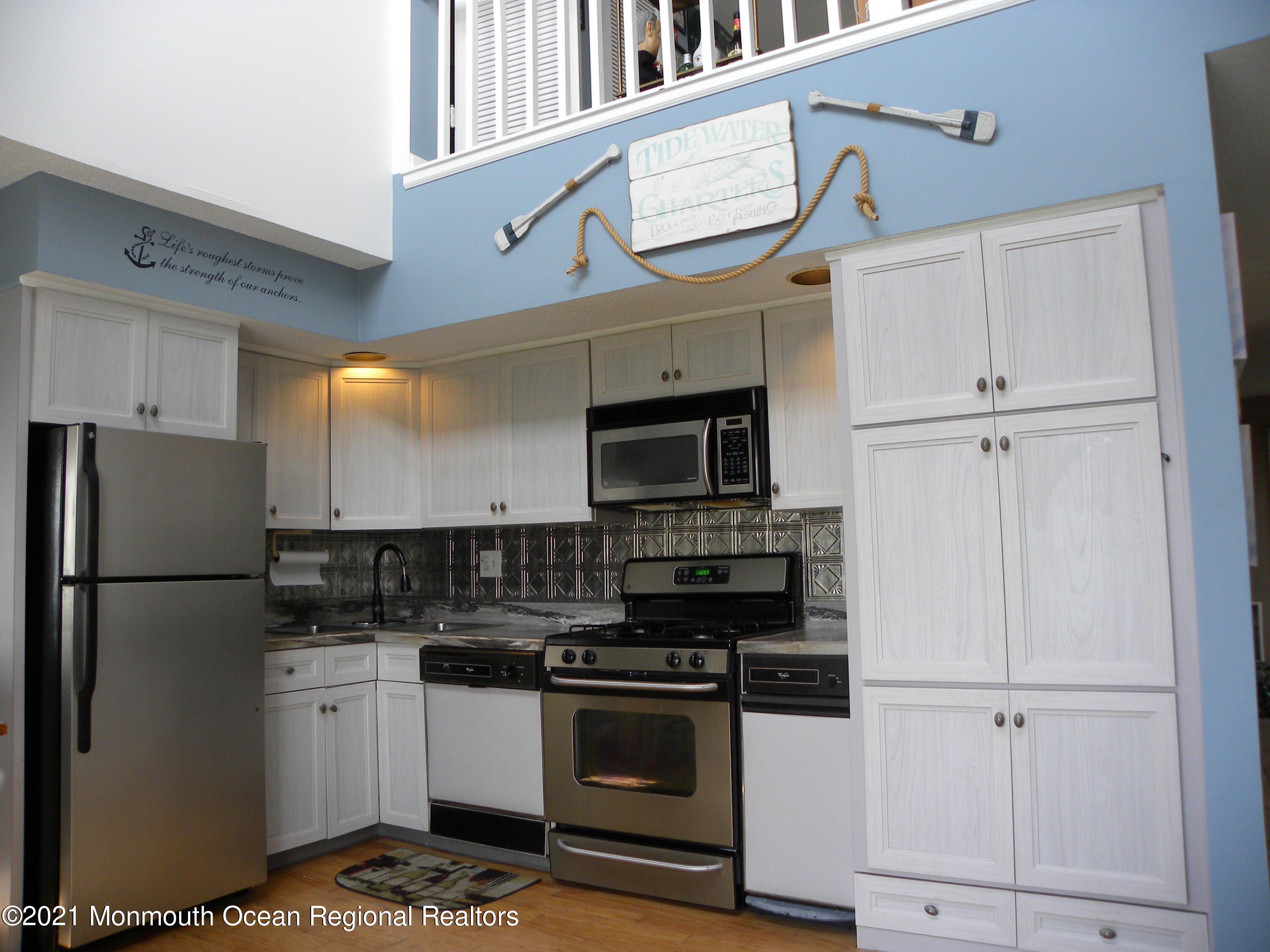 337 Lacey Road, Unit 37 Forked River, NJ 08731 - Photo 7 of 34 a kitchen with stainless steel appliances white cabinets and a refrigerator