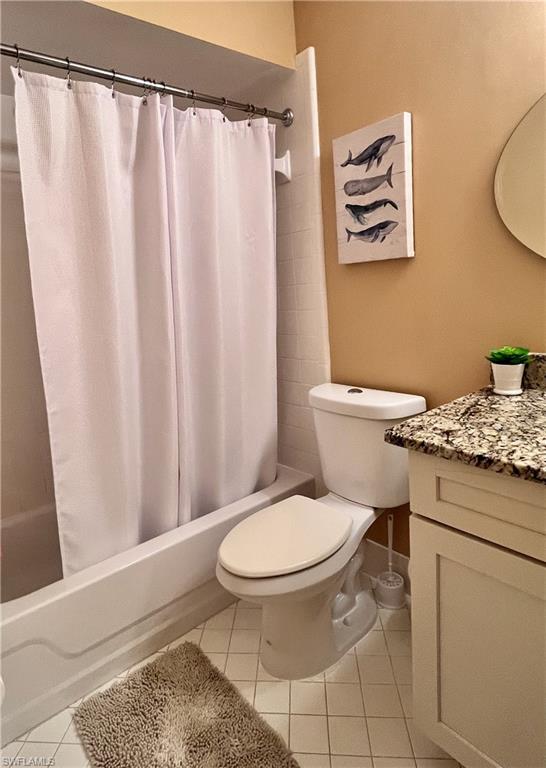 256 Palm Drive, Unit 6 Naples, FL 34112 - Photo 14 of 27 a bathroom with a toilet and a shower curtain