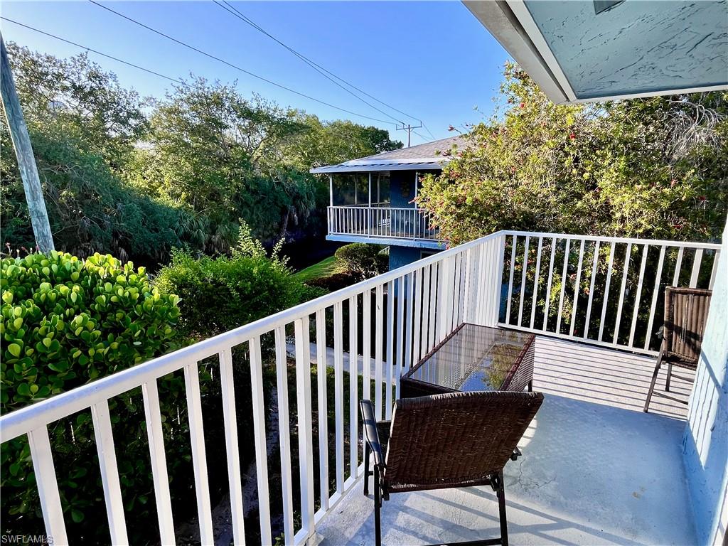 256 Palm Drive, Unit 6 Naples, FL 34112 - Photo 15 of 27 a view of a chair and table in the balcony