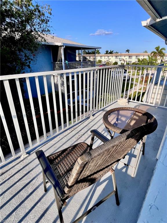256 Palm Drive, Unit 6 Naples, FL 34112 - Photo 16 of 27 a view of a balcony with chairs