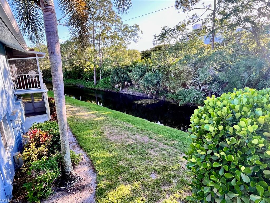 256 Palm Drive, Unit 6 Naples, FL 34112 - Photo 17 of 27 a view of a garden with a fountain