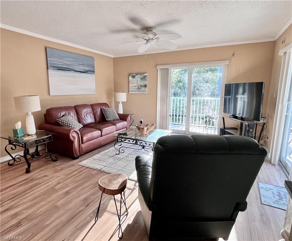 256 Palm Drive, Unit 6 Naples, FL 34112 - Photo 2 of 27 a living room with furniture and a large window