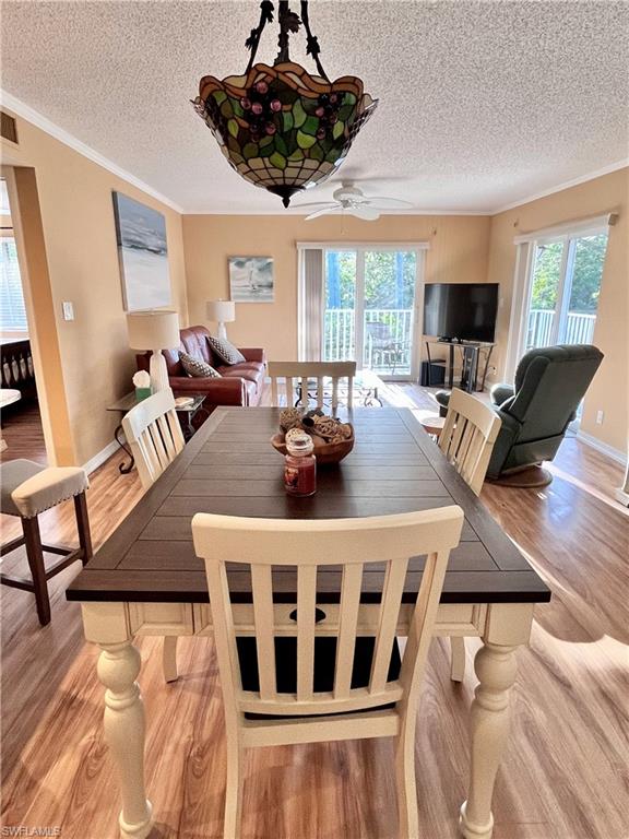 256 Palm Drive, Unit 6 Naples, FL 34112 - Photo 4 of 27 a view of a dining room with furniture window and wooden floor