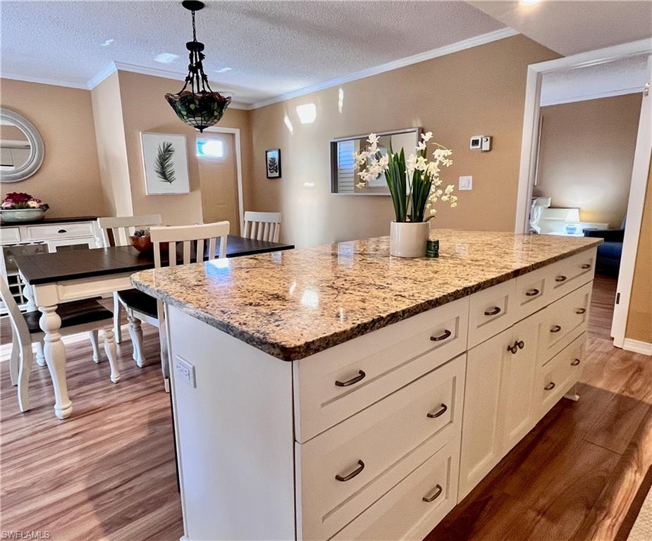 256 Palm Drive, Unit 6 Naples, FL 34112 - Photo 6 of 27 a bathroom with a granite countertop sink and a mirror