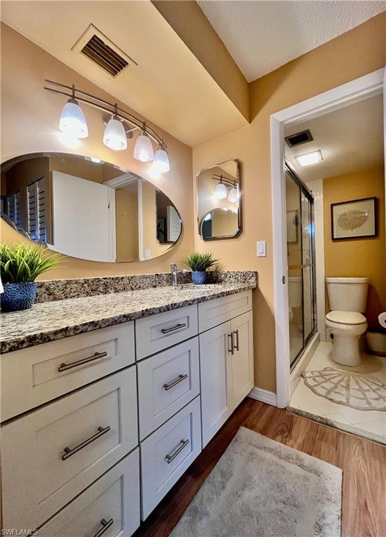 256 Palm Drive, Unit 6 Naples, FL 34112 - Photo 9 of 27 a spacious bathroom with a granite countertop sink and a mirror