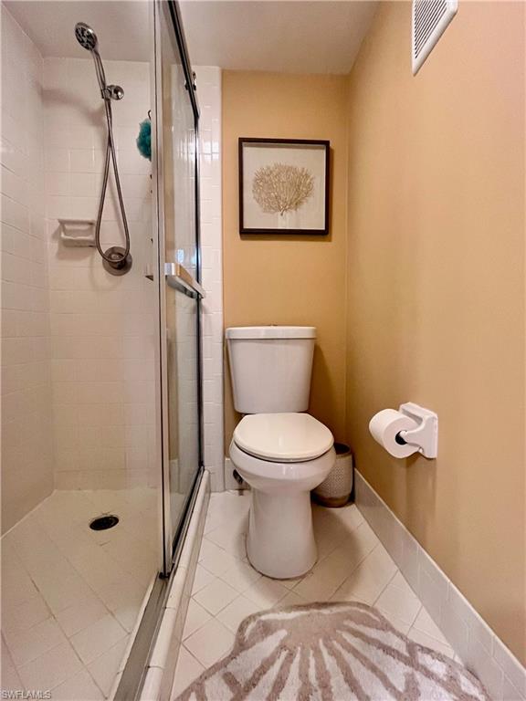 256 Palm Drive, Unit 6 Naples, FL 34112 - Photo 10 of 27 a bathroom with a toilet and a shower