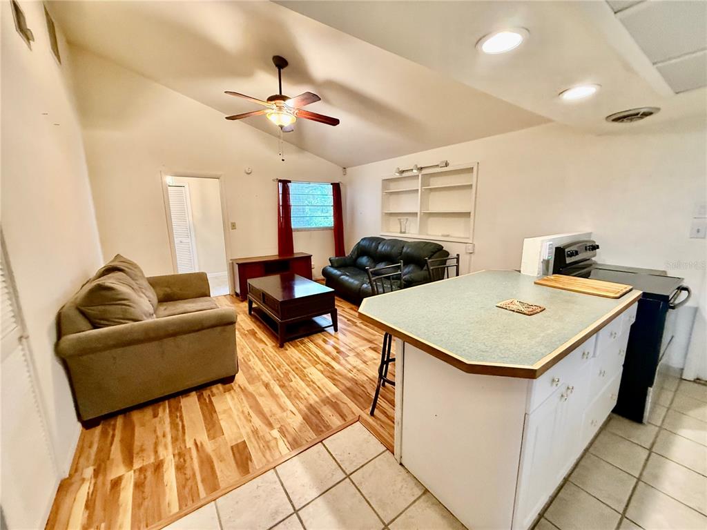 1004 Connecticut Road Tarpon Springs, FL 34689 - Photo 19 of 57 a living room with furniture and a chandelier