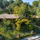 a view of a house with a yard and sitting area