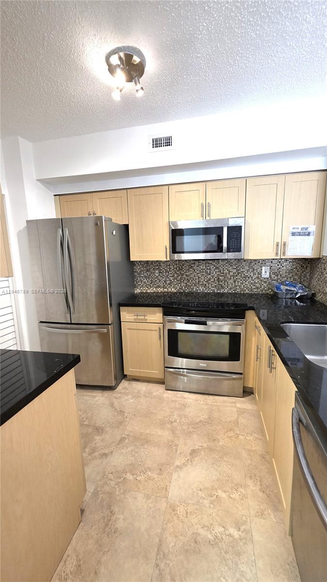 2090 West Preserve Way, Unit 301 Miramar, FL 33025 - Photo 1 of 21 a kitchen with granite countertop a refrigerator and a stove