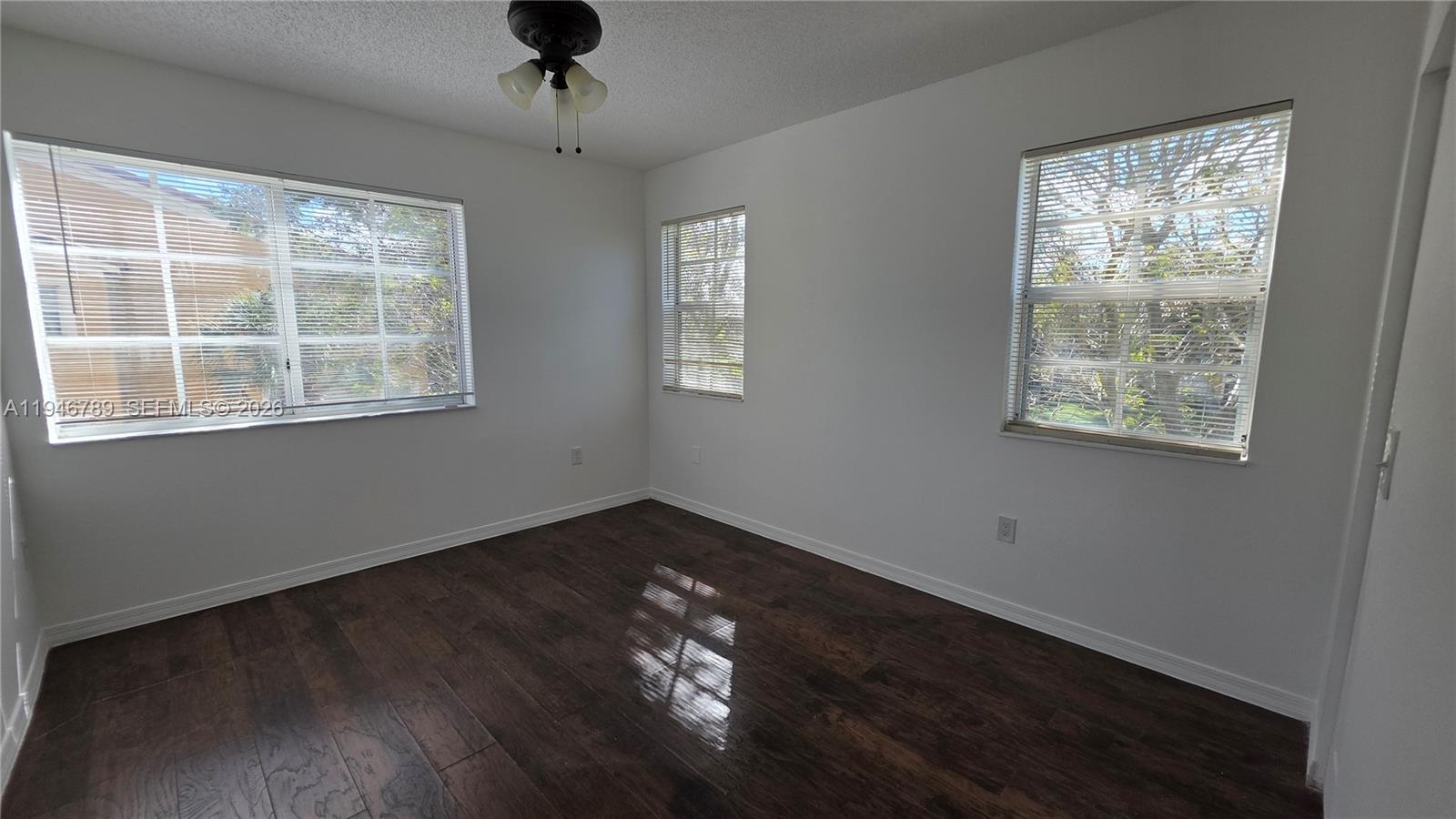 2090 West Preserve Way, Unit 301 Miramar, FL 33025 - Photo 11 of 21 a view of an empty room with wooden floor and a window