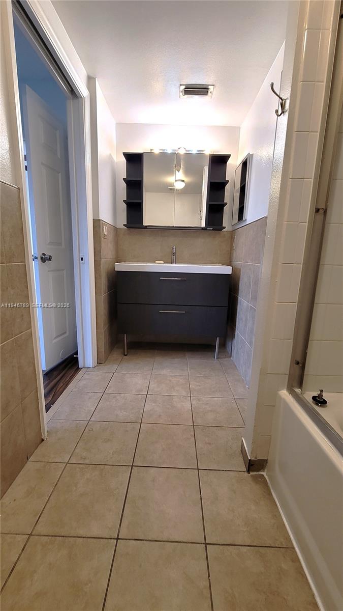 2090 West Preserve Way, Unit 301 Miramar, FL 33025 - Photo 14 of 21 a bathroom with a vanity and mirror