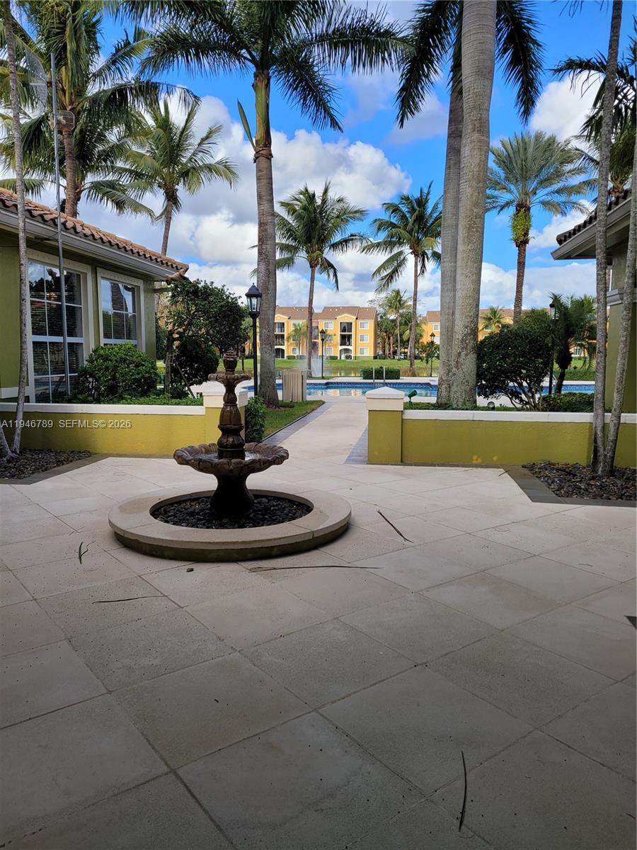 2090 West Preserve Way, Unit 301 Miramar, FL 33025 - Photo 20 of 21 a view of a swimming pool with a garden