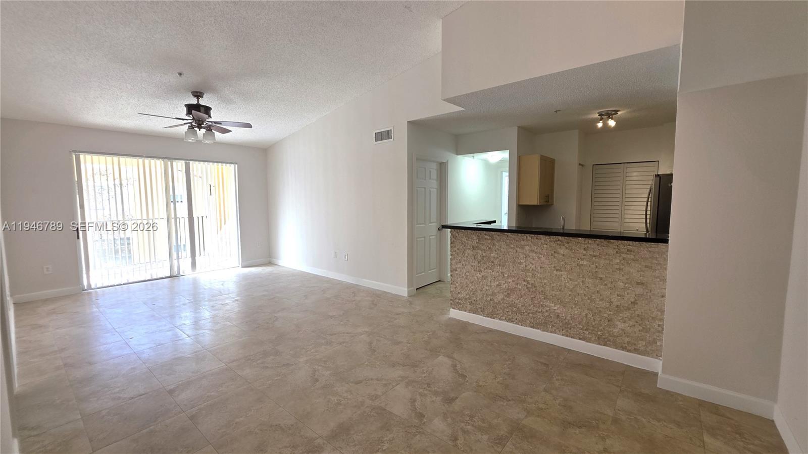 2090 West Preserve Way, Unit 301 Miramar, FL 33025 - Photo 4 of 21 an empty room with windows and cabinet