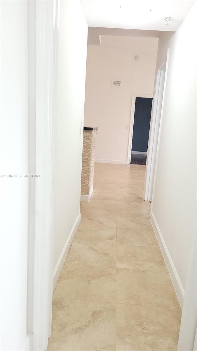 2090 West Preserve Way, Unit 301 Miramar, FL 33025 - Photo 6 of 21 a view of a hallway with wooden floor