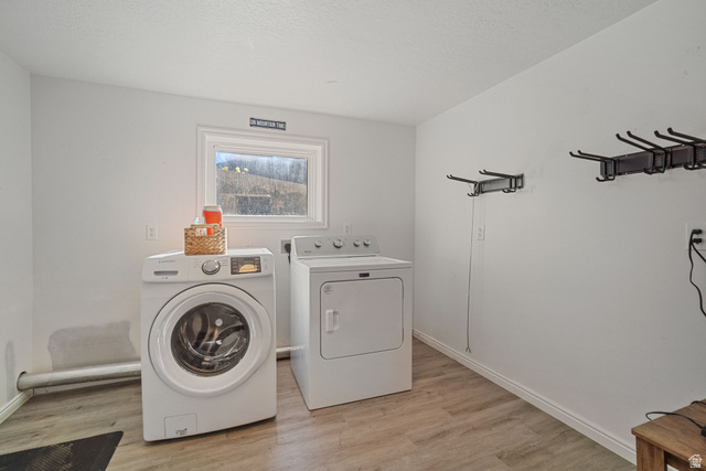 4426 South 3035 East Holladay, UT 84124 - Photo 31 of 49 Laundry room with light wood-style flooring and independent washer and dryer